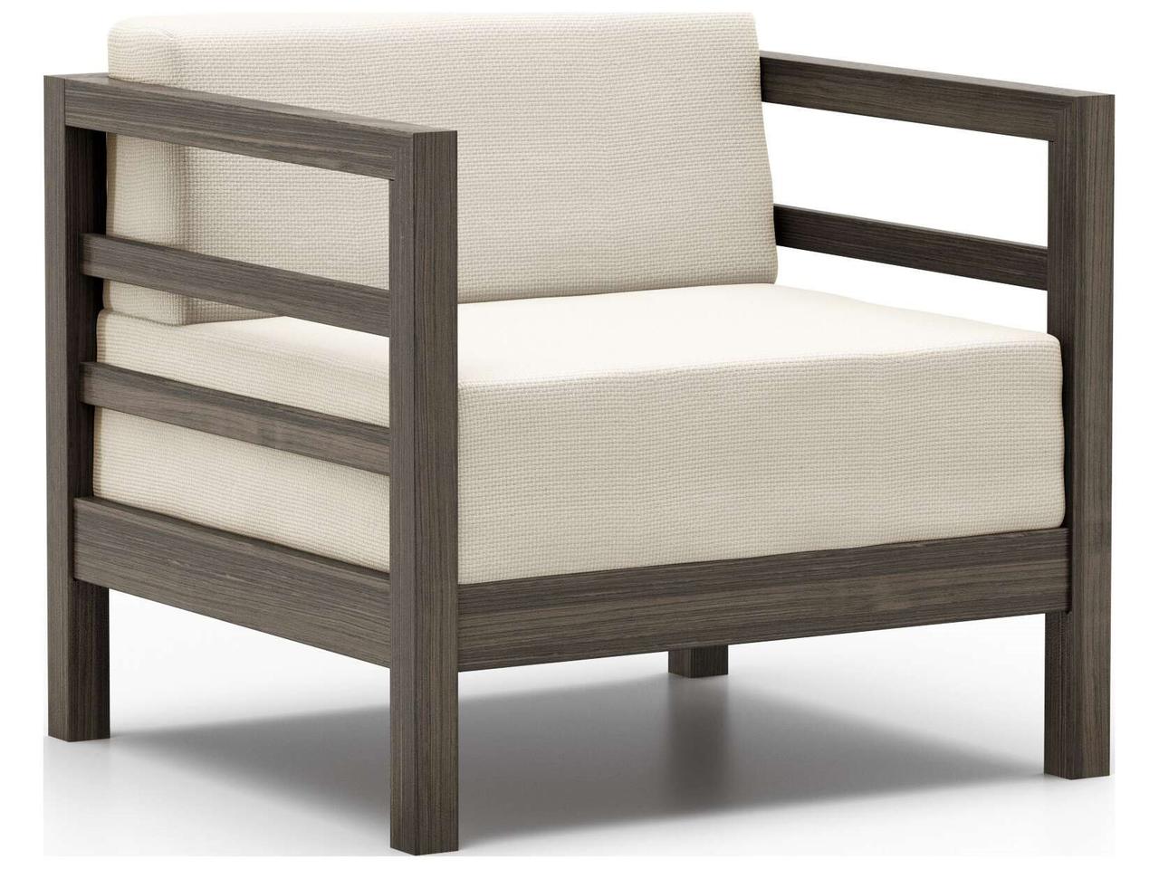 Lounge chair with light cushion and dark wood frame on white background.