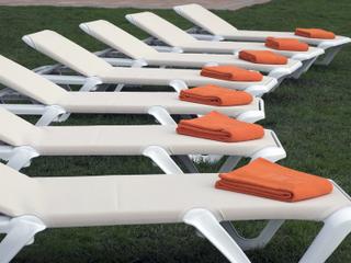 Grosfillex Nautical Pro Sling White Stacking Adjustable Outdoor Chaise Lounge in Khaki